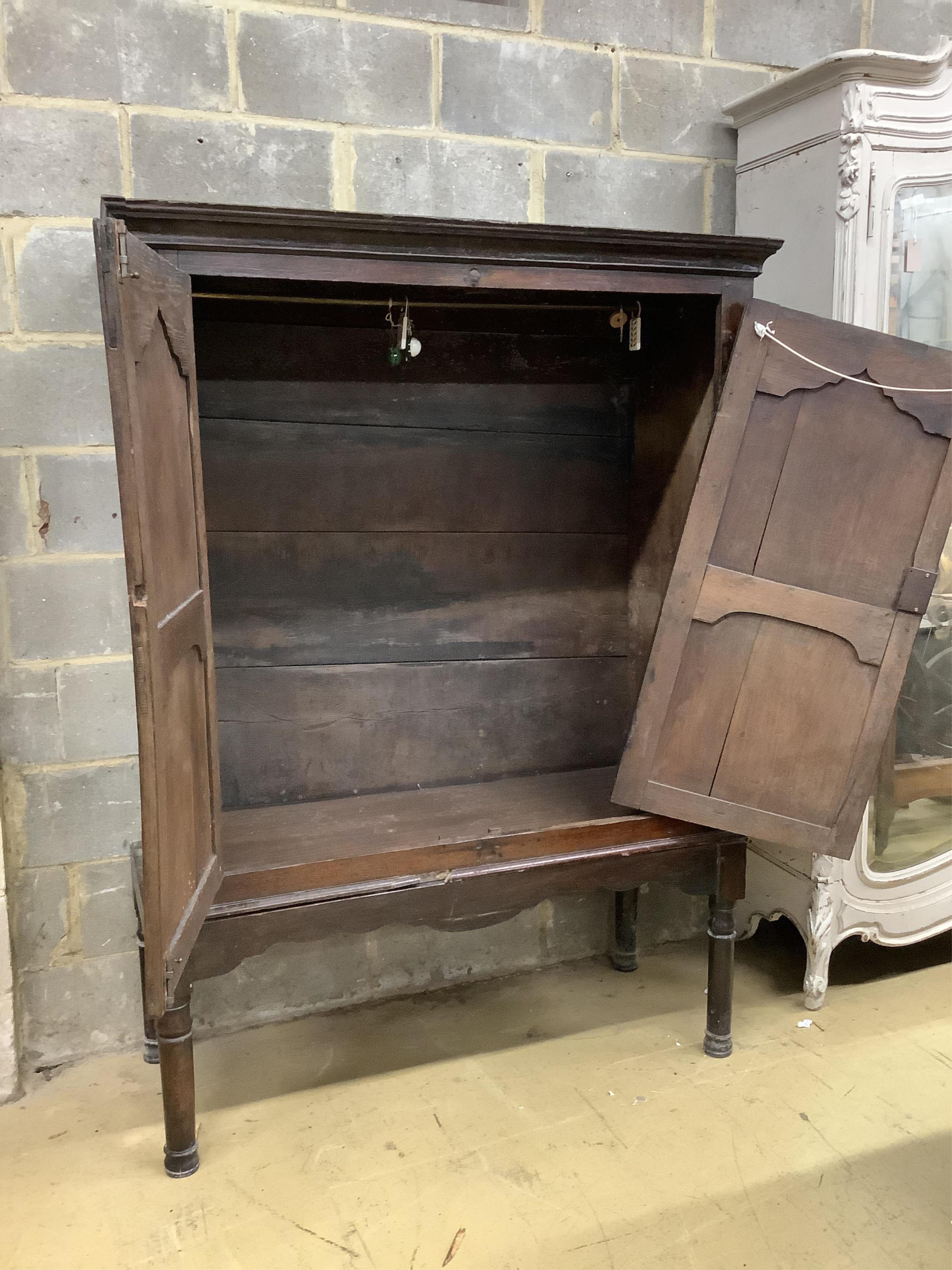 A mid 18th century carved oak cupboard, on associated stand, a.f., width 130cm, depth 55cm, height 178cm. Condition - poor